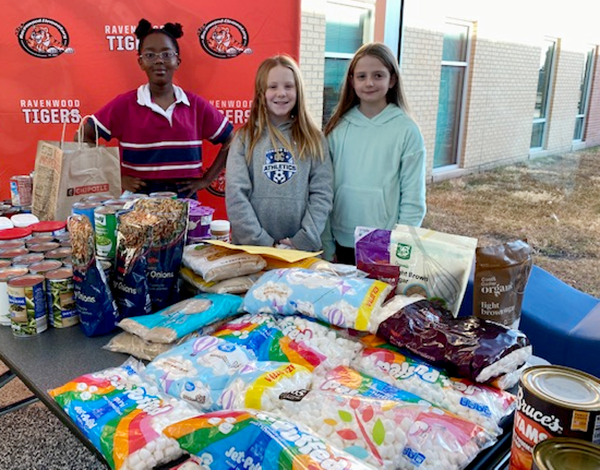 students and table of donated food items